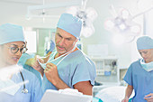 Surgeons with clipboard discussing paperwork