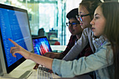 Students programming at computer