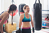 Laughing boxers next to punching bags