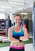 Portrait confident, female boxer in gym