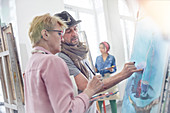 Artists painting in art class studio