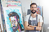 Portrait male artist painting in art studio