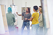 Students listening to instructor sketching