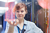 Female IT technician holding futuristic tablet
