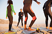 Young surfer teaching family surfing