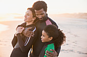 Affectionate family in wet suits hugging