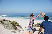 Woman placing hat on boyfriend