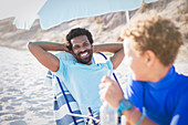 Father at son on sunny summer beach