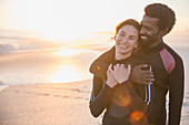 Smiling couple in wet suits