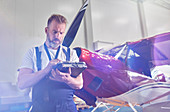 Male mechanic performing diagnostics