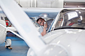 Mechanic engineer examining airplane wing