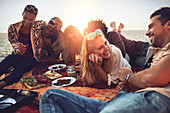 Young friends hanging out, enjoying picnic