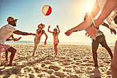 Playful young friends playing with beach ball