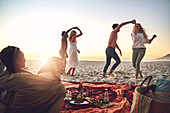 Young couples dancing, enjoying picnic