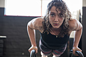 Portrait determined woman doing push-ups