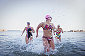 Female swimmers running