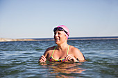 Smiling female swimmer swimming