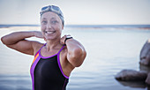 Portrait female swimmer adjusting bathing suit