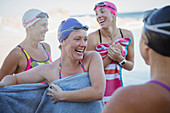 Laughing female swimmers drying off with towels