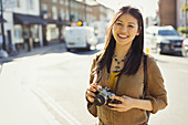 Portrait female tourist with camera