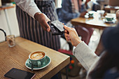 Customer paying worker with contactless payment