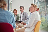 People listening in group therapy session