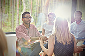 Attentive man listening to woman in group therapy