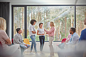 Women standing and talking in group therapy