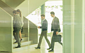 Business people walking, ascending stairs