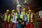 Portrait confident supervisor and steelworkers