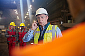 Steelworker supervisor talking on smart phone