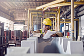 Steelworker with clipboard in steel mill