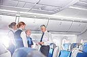 Pilot and flight attendants talking, preparing