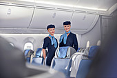 Portrait female flight attendants on airplane