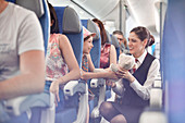 Girl showing teddy bear to flight attendant