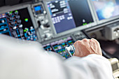 Pilot flying airplane in cockpit