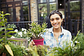 Portrait woman gardening with potted plants
