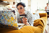 Young woman and credit card online shopping