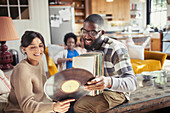 Couple looking at vinyl records in living room