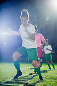 Soccer players practicing agility sports drill
