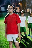 Portrait young soccer player at night