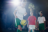 Soccer player practicing, kneeing the ball