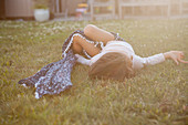 Serene girl laying in summer grass