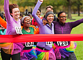 Women friend runners in tutus running