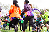 Female charity run runners running in tutus