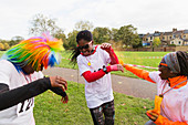 Playful runners celebrating, throwing Holi powder