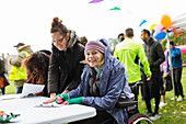 Woman in wheelchair checking in for race