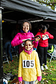 Portrait smiling, mother and daughter runners tent