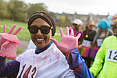 Portrait runner with pink Holi powder hands