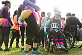 Woman in wheelchair at charity race in park